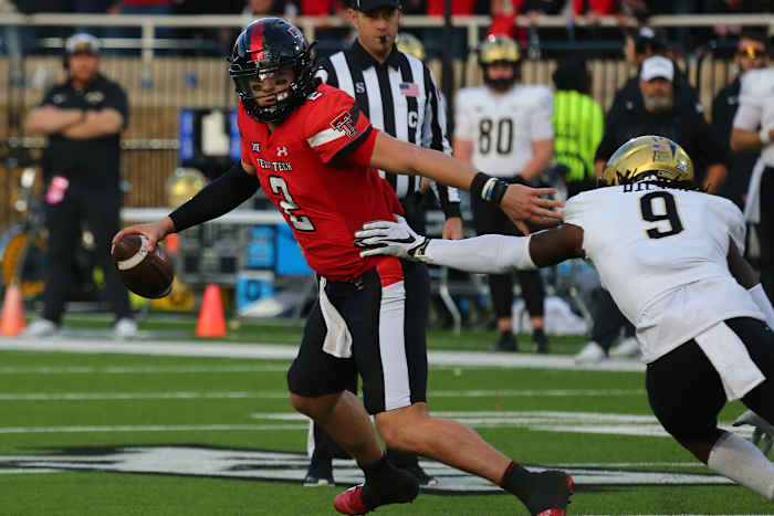 Texas Tech Red Raiders quarterback Behren Morton (2) is pressured by Central Florida Knights defensive safety Jireh Wilson (9) in the first half at Jones AT&T Stadium and Cody Campbell Field.